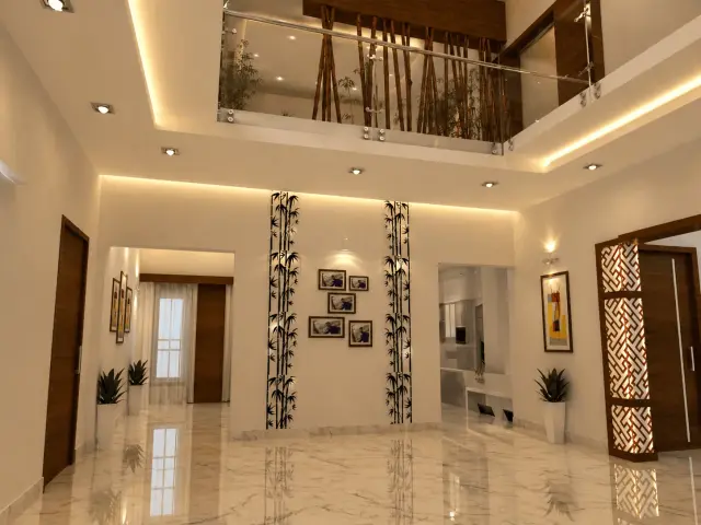 Double-height living area with a glass-railed upper landing, bamboo motif pillars and a carved wooden jaali screen beside the doorway